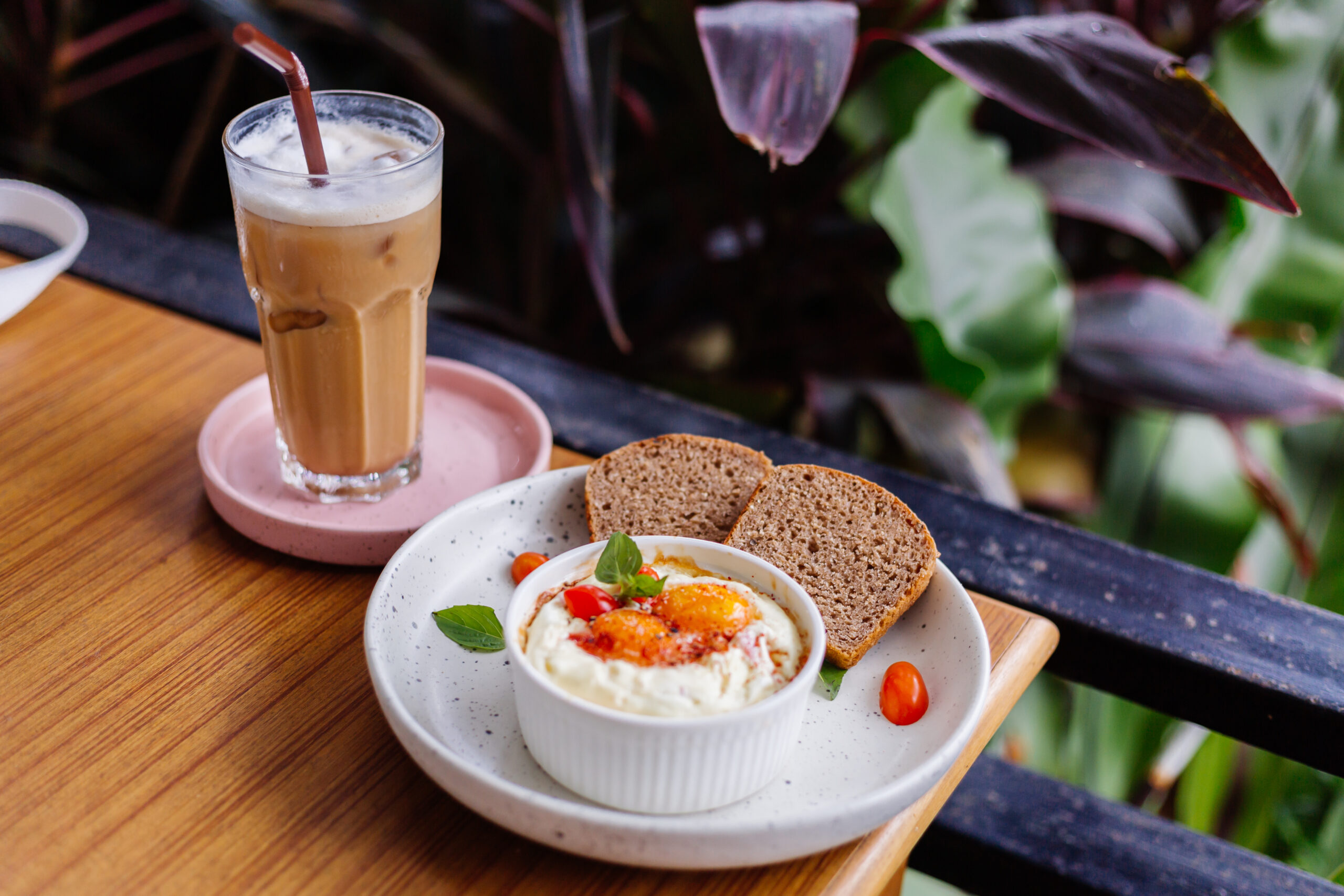 baked-two-eggs-with-ham-cheese-round-bowl-two-pieces-brown-healthy-bread-side