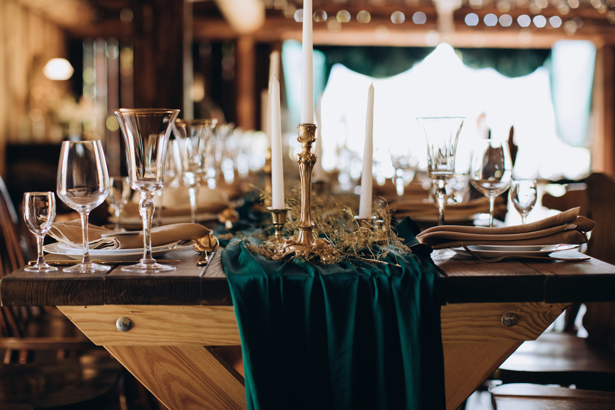 Elegant wooden wedding table for dinner in rustic style with candles
