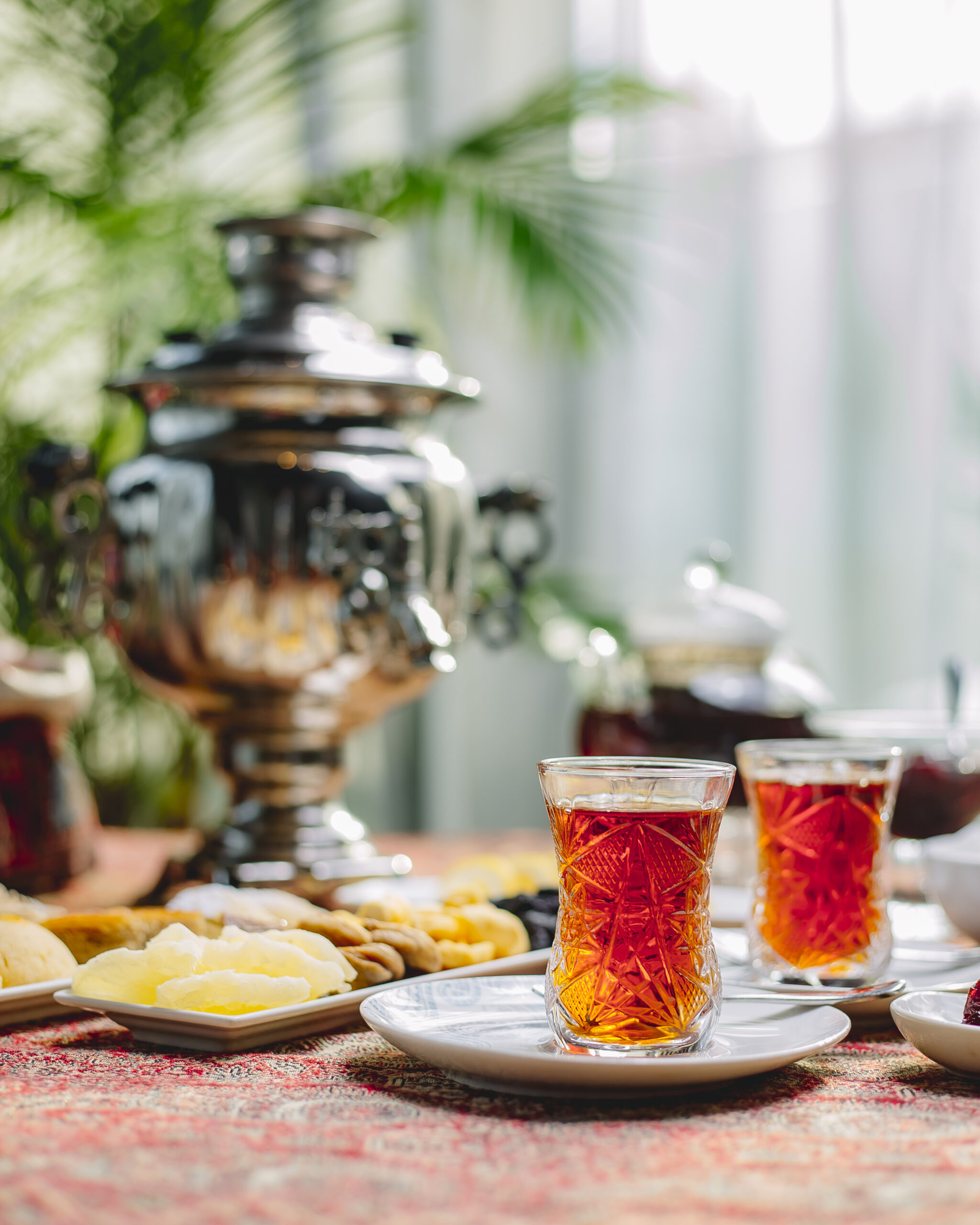side view two tea in armuda with sweets
